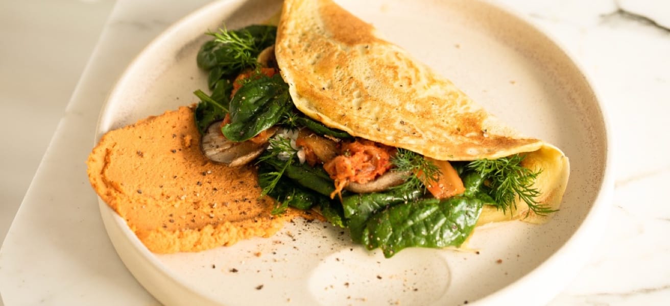 omelette with spinach and tomatoes on a plate